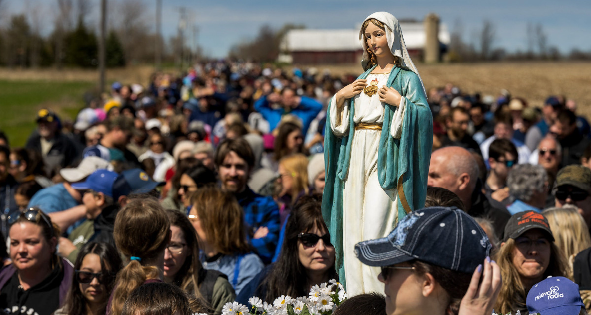 A statue of Mary carried among Walk to Mary pilgrims