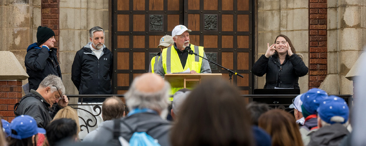Walk to Mary organizers address pilgrims gathered outside a church